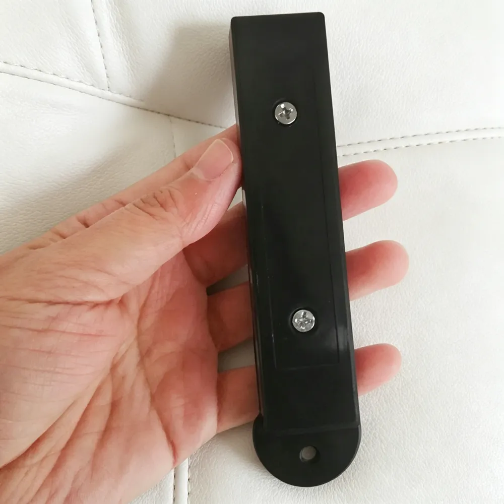 Handheld shot of black long strip hook lock magnetic detacher